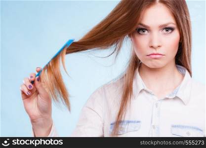 Healthy look concept. Girl combing brushing her hair by using plastic comb. Young woman taking care of everyday hygiene and natural beauty.. Long haired woman combing her hair.
