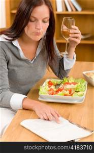 Healthy lunch at home attractive woman read magazine drink wine