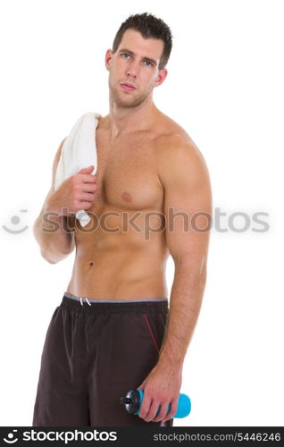 Healthy muscular man with towel and water bottle after workout