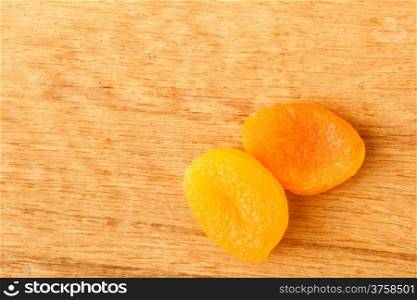 Healthy nutrition diet. Dried apricots on wooden table background.