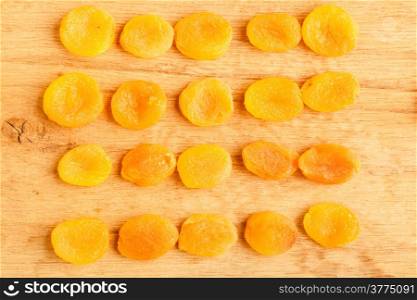 Healthy nutrition diet. Dried apricots set on wooden table background.