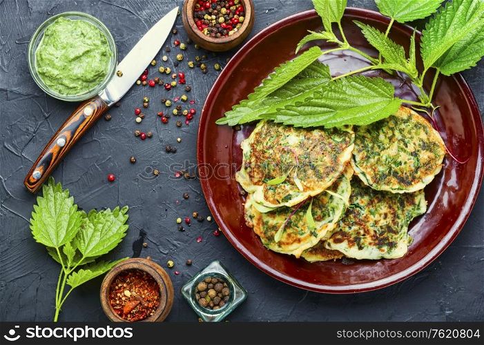 Healthy nutrition, diet fritters with nettles on a plate. Diet fritters with herbs