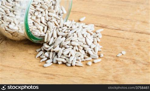 Healthy nutrition diet. sunflower seeds in glass jar on wooden table background.