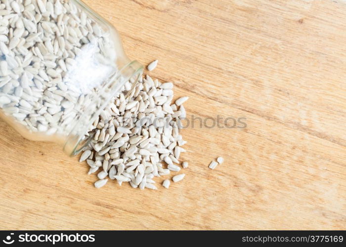 Healthy nutrition diet. sunflower seeds in glass jar on wooden table background.