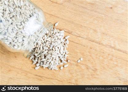 Healthy nutrition diet. sunflower seeds in glass jar on wooden table background.