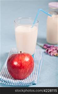 Healthy nutrition with fresh milk and red apple