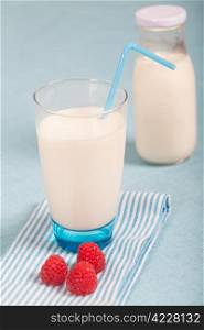 Healthy nutrition with fresh milk and red raspberry fruits