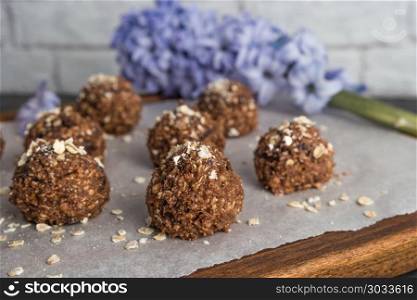 Healthy organic energy granola balls. Healthy organic energy granola balls with oat flakes, peanuts, dates, cacao, banana, chocolate and honey - vegan vegetarian raw snack or meal