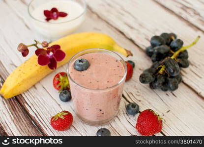 healthy organic fruit and nuts smoothie on wooden board