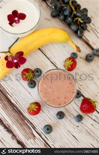 healthy organic fruit and nuts smoothie on wooden board