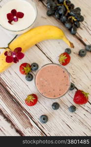 healthy organic fruit and nuts smoothie on wooden board