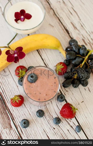 healthy organic fruit and nuts smoothie on wooden board