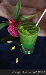 Healthy organic green smoothie. Healthy organic green smoothie with basil mint and lemon