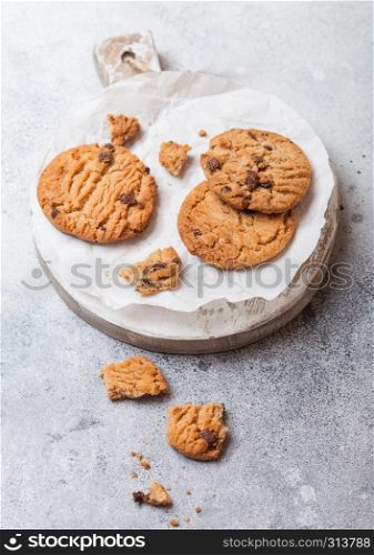 Healthy organic oat cookies with chocolate on wooden board on stone kitchen table background.