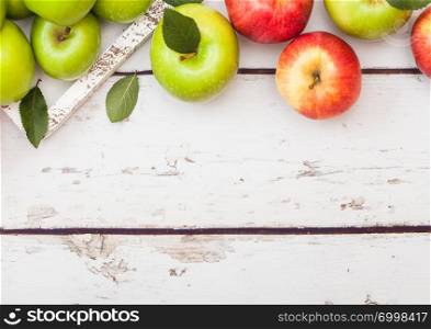 Healthy organic red and green apples with leaf on wood background.