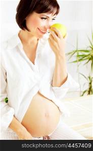 Healthy pregnant lady eating green apple, diet and organic nutrition concept