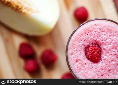 healthy raspberry and melon juice over wood