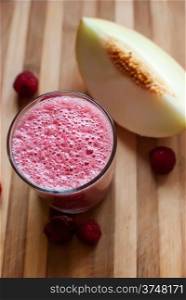 healthy raspberry and melon juice over wood