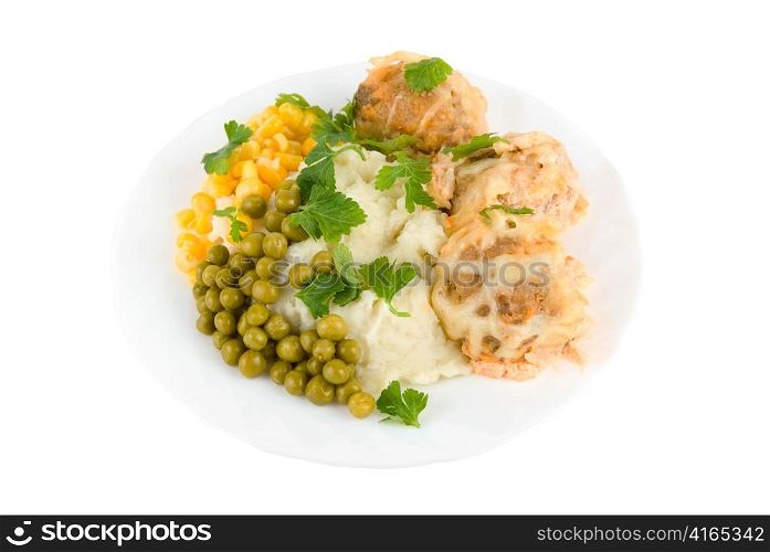 Healthy restaurant food: meatballs, potatoes, verdure, peas and corn on white
