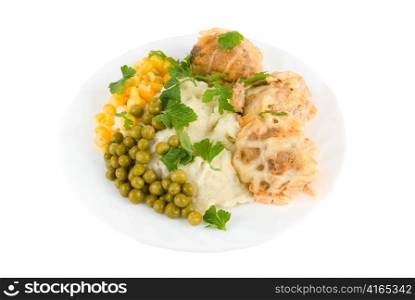Healthy restaurant food: meatballs, potatoes, verdure, peas and corn on white