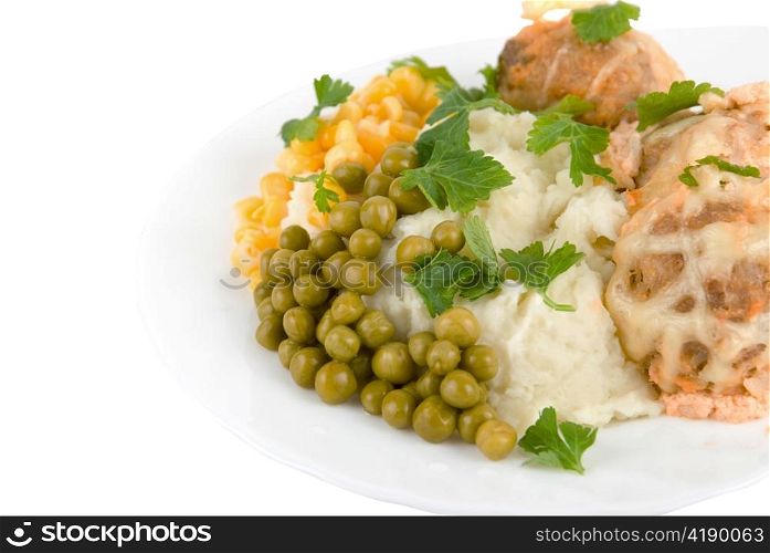 Healthy restaurant food: meatballs, potatoes, verdure, peas and corn on white. Close up.