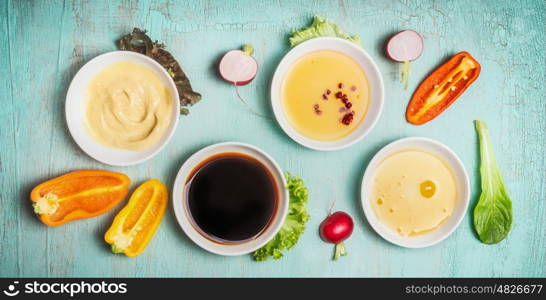 Healthy salad dressing ingredients in bowls: balsamic, mustard,olive oil and honey, top view. Diet eating, Vegetarian or vegan food concept