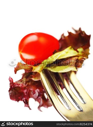 Healthy salad on the silver fork isolated on white background, conceptual image of healthy eating &amp; diet