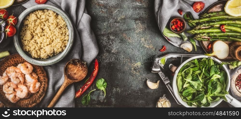 Healthy salad preparation with cooking spoon and superfood ingredients: quinoa, asparagus, fresh seasong , spices and shrimps on rustic background, top view, border
