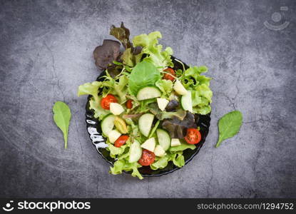 Healthy salad vegetable leaves mix salad with fruit and fresh lettuce tomato cucumber on plate on table fresh food eating concept