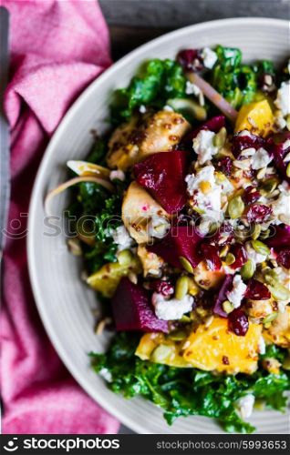 Healthy salad with grilled chicken,kale.beets and goat cheese