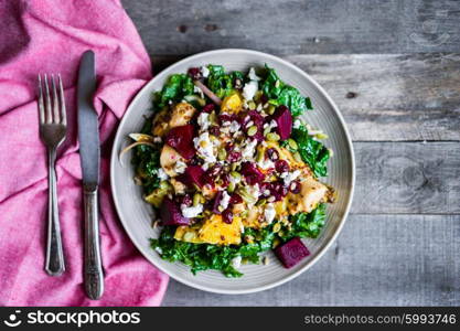 Healthy salad with grilled chicken,kale.beets and goat cheese