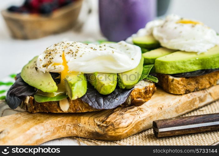 Healthy sandwich with avocado and poached eggs