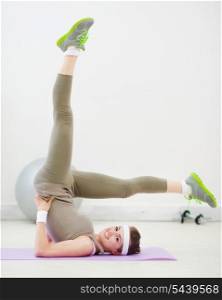 Healthy slim woman doing gymnastics exercises