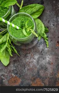 Healthy smoothie of fresh green spinach leaves. Food ingredients. Detox concept. Top view, selective focus. Vintage style toned picture