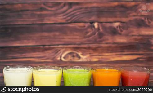 Healthy smoothies with fresh ingredients on a kitchen board