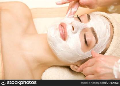Healthy Spa: Young Beautiful Relaxing Woman Having Moistening Mask Applied