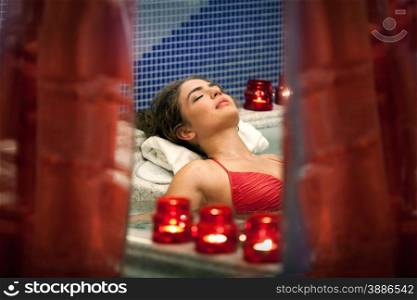 Healthy Spa: Young Beautiful Relaxing Woman Lying in the Bath.