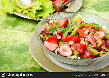 Healthy strawberry salad. dietary summer salad with strawberries, fruits and lettuce