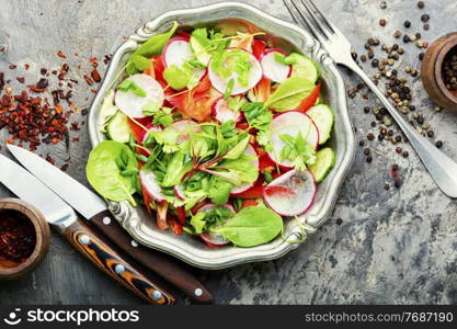 Healthy vegan salad made from radish,pepper,cabbage and greens.Salad with fresh vegetables and herbs. Plate of healthy vegetarian salad,diet menu