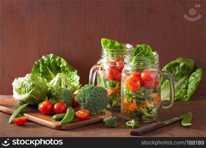 healthy vegetable salad in mason jar. tomato, broccoli, carrot, pea