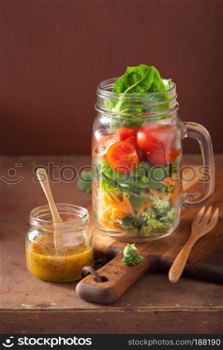 healthy vegetable salad in mason jar. tomato, broccoli, carrot, pea