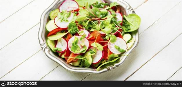 Healthy vegetable salad made from radish,pepper,cabbage and greens.Vegan food. Summer vegan salad