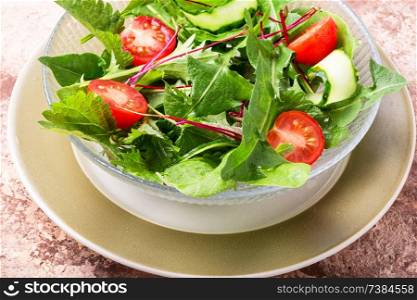 Healthy vegetable salad of fresh tomato, cucumber, herb and lettuce.Healthy food. Bowl of salad with greens
