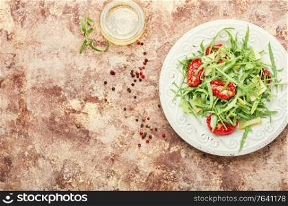 Healthy vegetable salad of sun dried tomato and arugula. Salad with sun dried tomatoes and arugula