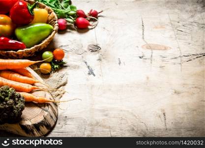 Healthy vegetables. Fresh vegetables with herbs. On wooden background.. Healthy vegetables.