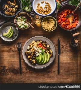 Healthy vegetarian meal. Bowl with chick peas puree, roasted vegetables , red paprika tomatoes stew, avocado and seeds . Clean eating or dieting food concept
