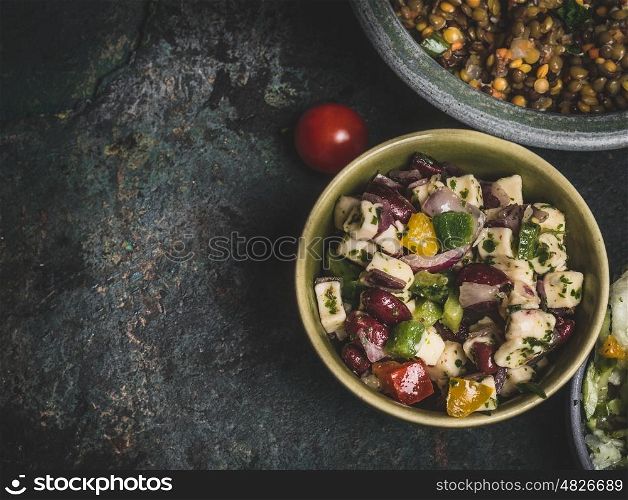 Healthy vegetarian red Beans salad with feta in bowl on rustic background, top view, close up, border. Diet eating, Vegetarian food concept