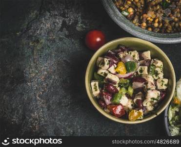 Healthy vegetarian red Beans salad with feta in bowl on rustic background, top view, close up, border. Diet eating, Vegetarian food concept