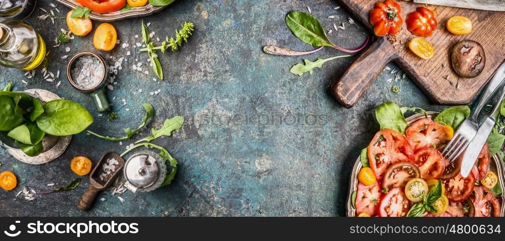 Healthy vegetarian salad making preparation with tomatoes on rustic background, top view, banner, copy space