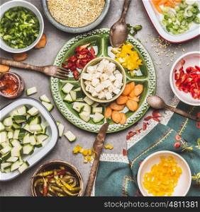 Healthy vegetarian salad preparation with Diced feta cheese, cut vegetables and pearl barley , top view. Diet nutrition concept